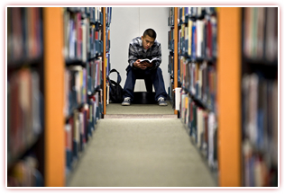 Student in library. Couresy of UCI Communications.